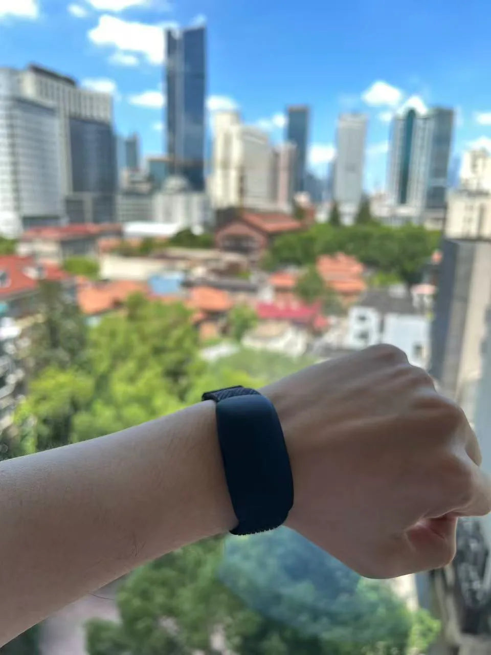 Jack Tai wearing the Memoket Gem against a city view